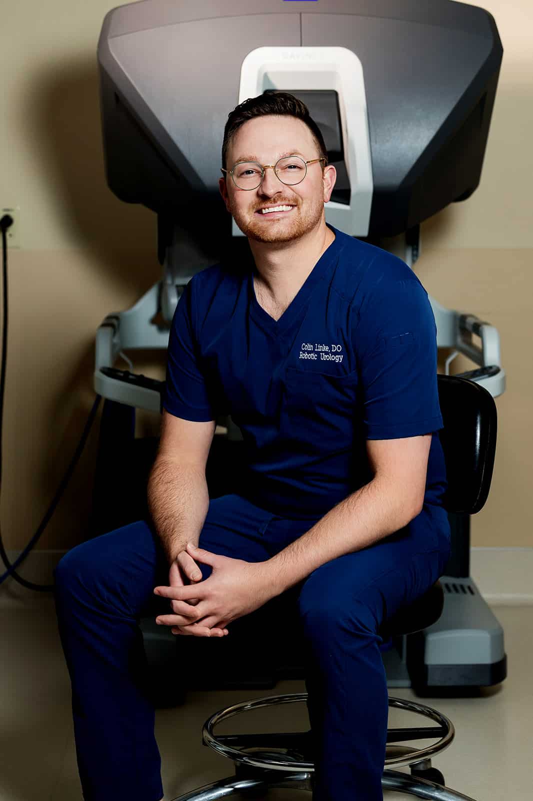 Dr. Colin Linke, DO, seated at the da Vinci SP single-port robotic system